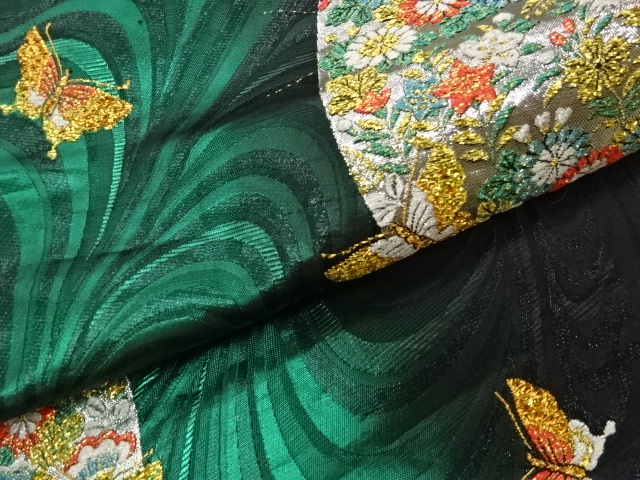  曲線に蝶・草花模様織出し袋帯